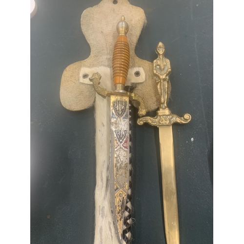 119 - AN ORNATE KNIFE IN AN ANIMAL SKIN SHEATH AND A BRASS LETTER OPENER