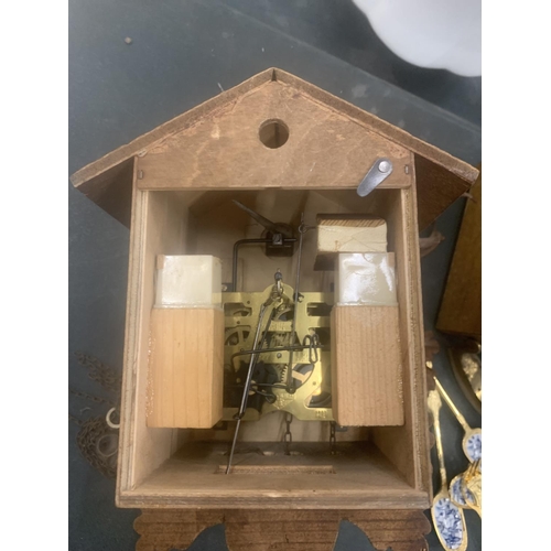 124 - A WOODEN CUCKOO CLOCK WITH ANIMAL CARVING