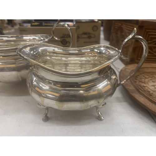 147 - A SILVER PLATED CREAM JUG AND SUGAR BOWL