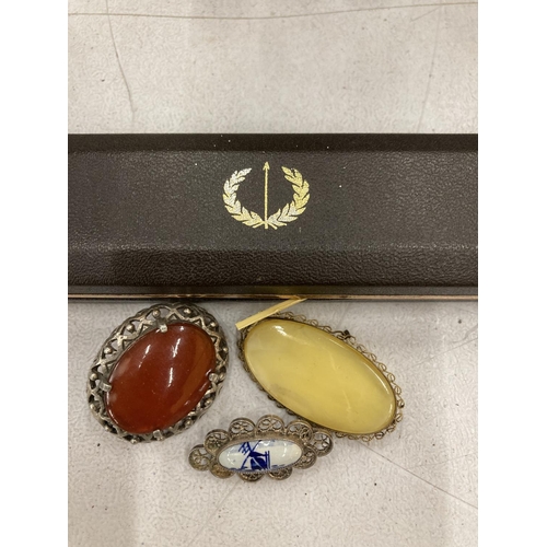 155 - AN AVIA WRISTWATCH BOXED PLUS THREE BROOCHES, TWO WITH STONES