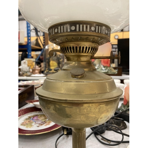 157 - A VINTAGE BRASS OIL LAMP WITH OPAQUE SHADE