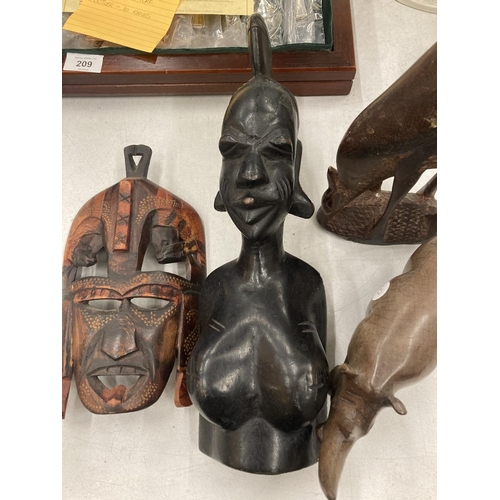 208 - FOUR CARVED AFRICAN STYLE WOODEN FIGURES TO INCLUDE A BUST OF A LADY, A MASK, RHINO AND DEER