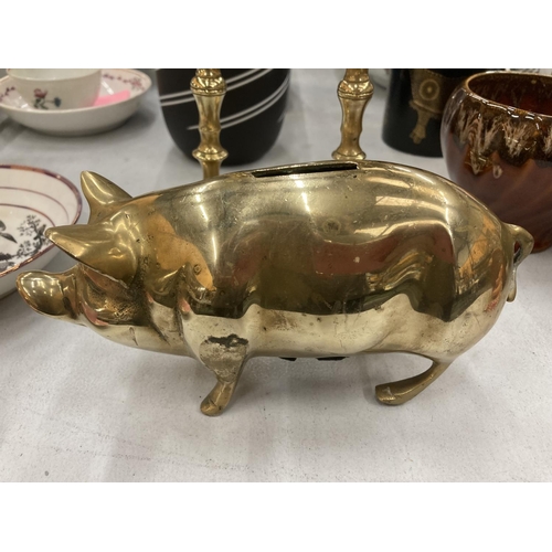 214 - A PAIR OF VINTAGE BRASS CANDLESTICKS AND A BRASS PIG MONEY BOX