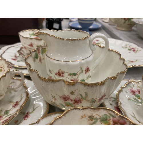 218 - AN ANTIQUE DIAMOND CHINA TEASET TO INCLUDE A LARGE NUMBER OF TRIOS, TWO CAKE PLATES, A CREAM JUG AND... 