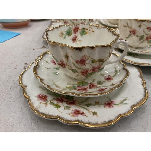 218 - AN ANTIQUE DIAMOND CHINA TEASET TO INCLUDE A LARGE NUMBER OF TRIOS, TWO CAKE PLATES, A CREAM JUG AND... 