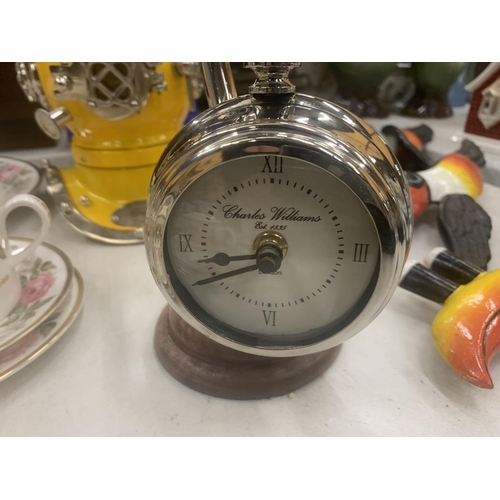 249 - A CHROME POCKET WATCH STYLE CLOCK ON A CHROME STAND WITH WOODEN BASE