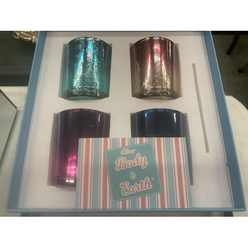 290 - A BOXED SET OF FOUR CANDLES IN HOLDERS PLUS FIVE BOXES OF ESSENTIAL OILS