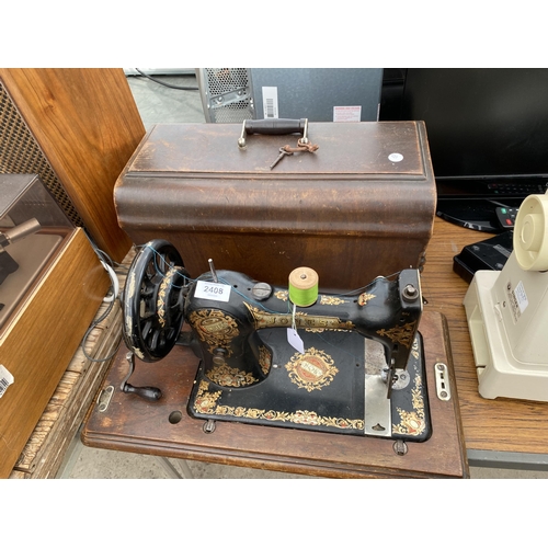 2408 - A VINTAGE JONES SEWING MACHINE WITH WOODEN CARRY CASE