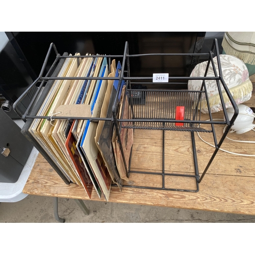 2411 - A RECORD RACK AND AN ASSORTMENT OF LP RECORDS