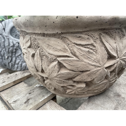 119 - A CONCRETE LEAF DESIGN PLANTER WITH BELLIS DAISYS AND PRIMULAS - NO VAT