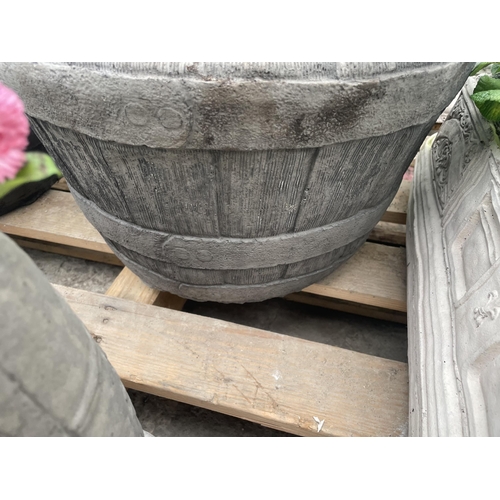 127 - A CONCRETE HALF BARREL DESIGN PLANTER WITH PRIMULAS AND BELLIS DAISYS NO VA