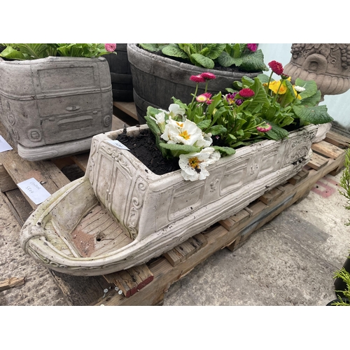 129 - A CONCRETE MODEL OF A CANAL BARGE PLANTED WITH PRIMULAS AND BELLIS DAISYS - NO VAT