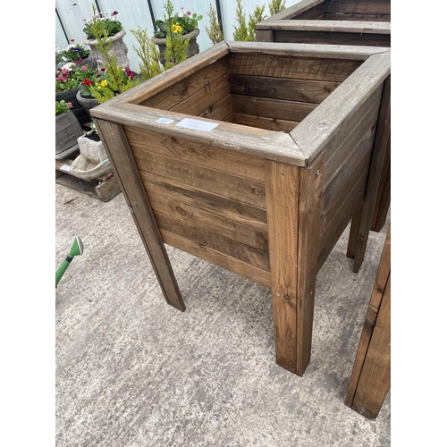 132 - TWO LARGE WOODEN PLANTERS ON LEGS NO VAT