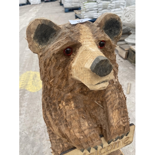 82 - A CARVED WOODEN ORNAMENT OF A WELCOME BEAR 64 CM HIGH NO VAT