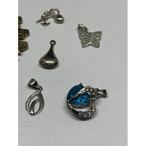 561 - ELEVEN VARIOUS SILVER CHARMS AND PENDANTS