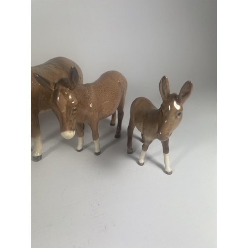 712 - A GROUP OF FOUR BESWICK DONKEY FIGURES, ONE LEG A/F