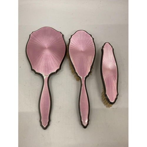 20 - AN ART DECO HALLMARKED SILVER AND PINK ENAMEL THREE PIECE DRESSING SET, HALLMARKS FOR BIRMINGHAM, 19... 