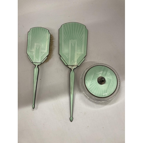 25 - AN ART DECO HALLMARKED SILVER AND FLORAL GREEN ENAMEL THREE PIECE DRESSING SET