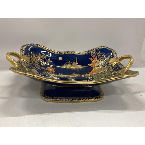 35 - A CARLTON WARE TWIN HANDLED PEDESTAL BOWL DECORATED IN THE 'MIKADO' PATTERN WITH GILT DESIGN ON A CO... 