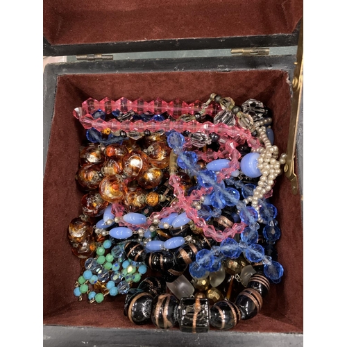 159 - A QUANTITY OF GLASS NECKLACES IN A VINTAGE DECORATIVE BOX