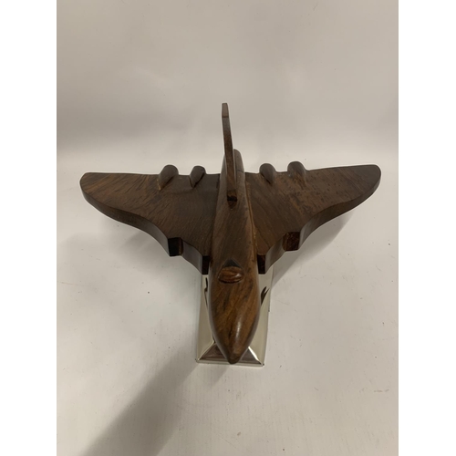 175 - A WOODEN MODEL OF A VULCAN BOMBER ON A CHROME BASE