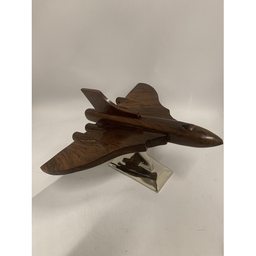 175 - A WOODEN MODEL OF A VULCAN BOMBER ON A CHROME BASE