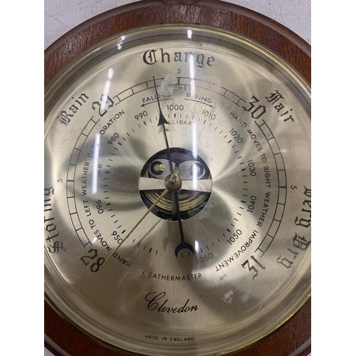 183 - A WEATHERMASTER, CLEVEDON ROUND BRASS BAROMETER WITH WOODEN FRAME