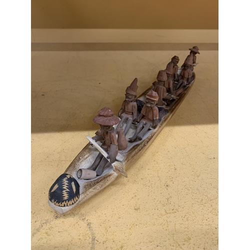 188 - AN AFRICAN STYLE WOODEN BOAT SCULPTURE WITH EIGHT PEOPLE