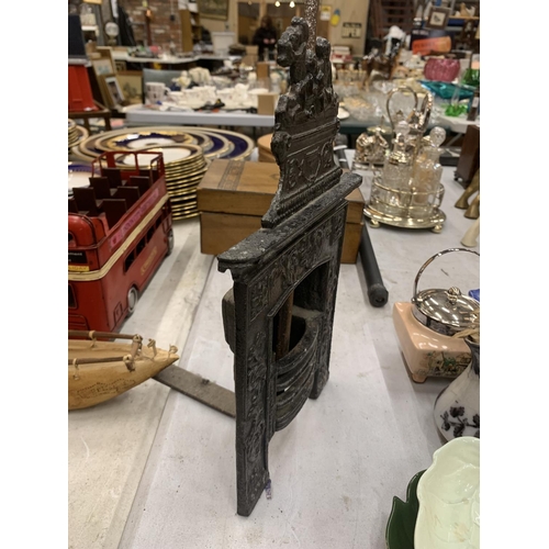 195 - A VINTAGE MINIATURE CAST FIREPLACE WITH POKER HEIGHT 31CM, WIDTH 19CM