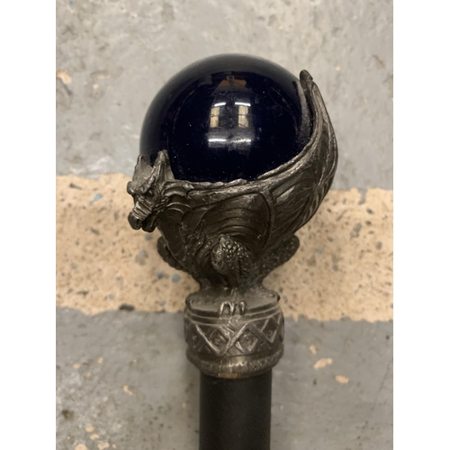 213 - A WALKING STICK WITH A BLUE GLASS ORB AND DRAGON FINIAL