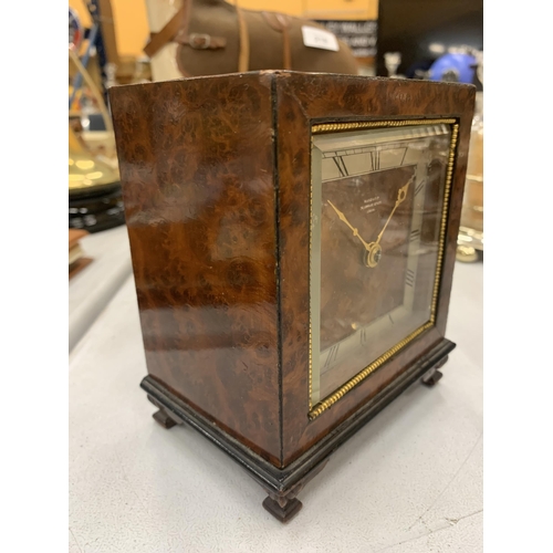 216 - A PRE 1936 BURR WALNUT MANTLE CLOCK WITH KEY - MARKED SEARLE & CO, LOMBARD STREET, LONDON