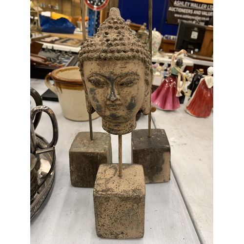 225 - TWO STONE FEATHERS ON PLINTHS AND A BUDDAHS HEAD ON A PLINTH