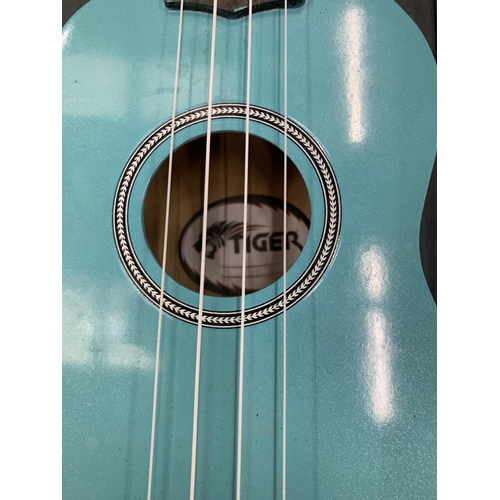 228 - A 'TIGER' TURQUOISE COLOURED UKELELE