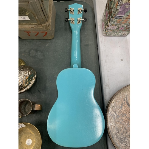 228 - A 'TIGER' TURQUOISE COLOURED UKELELE