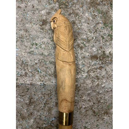 232 - A WOODEN WALKING STICK WITH A CARVED OWL FINIAL