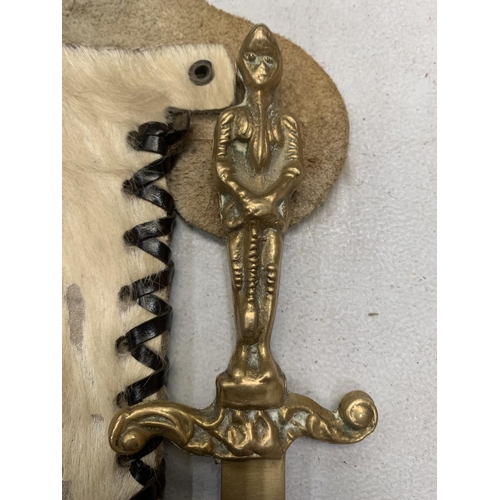 248 - AN ORNATE KNIFE IN AN ANIMAL SKIN SHEATH AND A BRASS LETTER OPENER