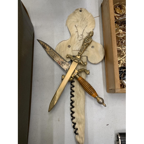 248 - AN ORNATE KNIFE IN AN ANIMAL SKIN SHEATH AND A BRASS LETTER OPENER