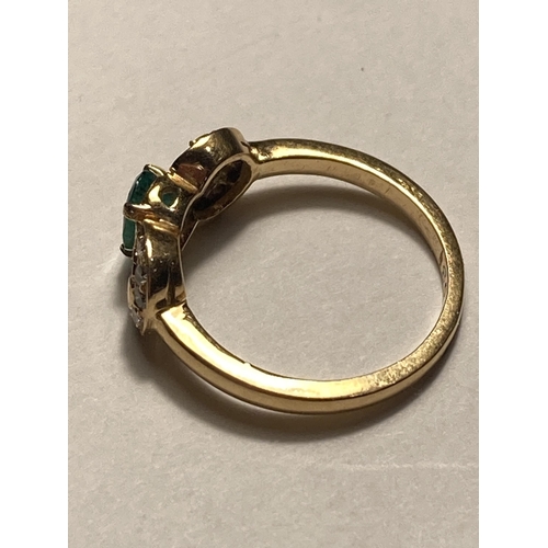 505 - A 18 CARAT GOLD RING WITH A CENTRE GREEN STONE AND DIAMONDS SIZE J/K