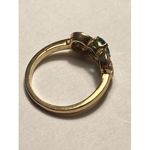 505 - A 18 CARAT GOLD RING WITH A CENTRE GREEN STONE AND DIAMONDS SIZE J/K