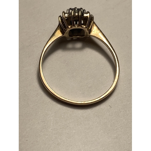 511 - A 9 CARAT GOLD RING WITH A CENTRE SAPPHIRE SURROUNDED BY CUBIC ZIRCONIAS SIZE O/P