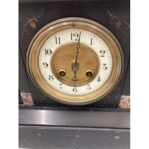 827 - A VINTAGE BLACK MARBLE MANTLE CLOCK WITH PILLAR DECORATION VENDOR STATES IN WORKING ORDER BUT NO WAR... 