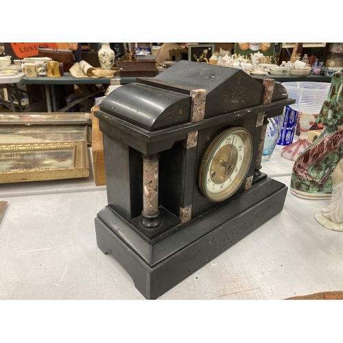 827 - A VINTAGE BLACK MARBLE MANTLE CLOCK WITH PILLAR DECORATION VENDOR STATES IN WORKING ORDER BUT NO WAR... 