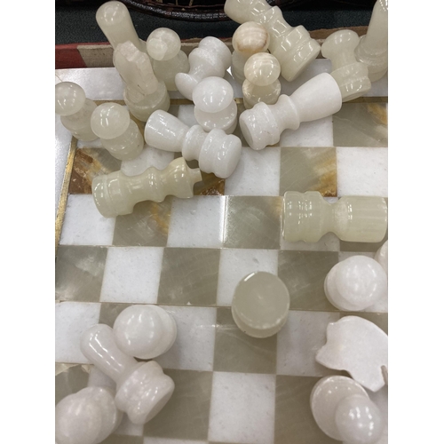 830 - A MARBLE STYLE CHESS BOARD WITH PIECES