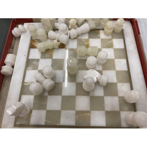 830 - A MARBLE STYLE CHESS BOARD WITH PIECES