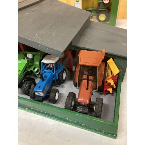 879 - A WOODEN TRACTOR GARAGE CONTAINING A QUANTITY OF TRACTORS AND TRAILERS