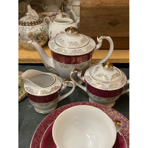 887 - A VINTAGE JAPANESE TEASET TO INCLUDE A TEAPOT, CREAM JUG, LIDDED SUGAR BASIN, CUPS, SAUCERS AND SIDE... 