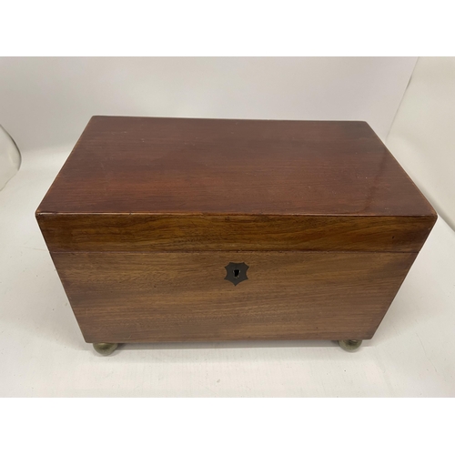 51 - A VICTORIAN MAHOGANY TEA CADDY WITH THREE INNER COMPARTMENTS, ON BUN FEET