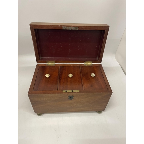 51 - A VICTORIAN MAHOGANY TEA CADDY WITH THREE INNER COMPARTMENTS, ON BUN FEET