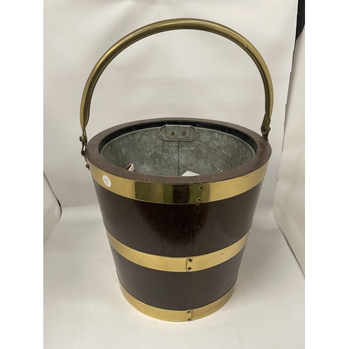 69 - A VINTAGE OAK AND BRASS BOUND BUCKET WITH BRASS HANDLE AND INNER GALVANISED LINER