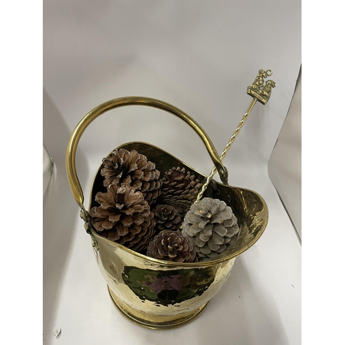 75 - A VINTAGE HAMMERED EFFECT BRASS COAL BUCKET FILLED WITH PINE CONES